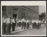 Police at the entrance to the Strutwear Knitting Company